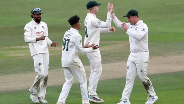 Farhan Ahmed of Nottinghamshire celebrates with his team-mates after taking the wicket of Paul Walter