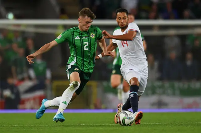 Eric Veiga of Luxembourg controls the ball whilst under pressure from Conor Bradley