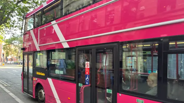 A pink translink metro bus