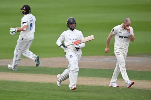 Tom Haines and Daniel Hughes of Sussex run a single off the bowling of James Harris of Glamorgan