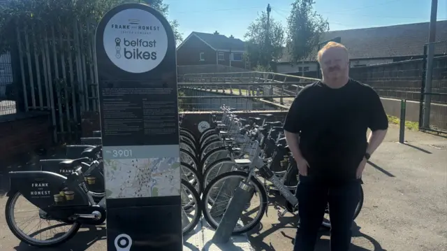 Brian Smyth standing in front of bikes