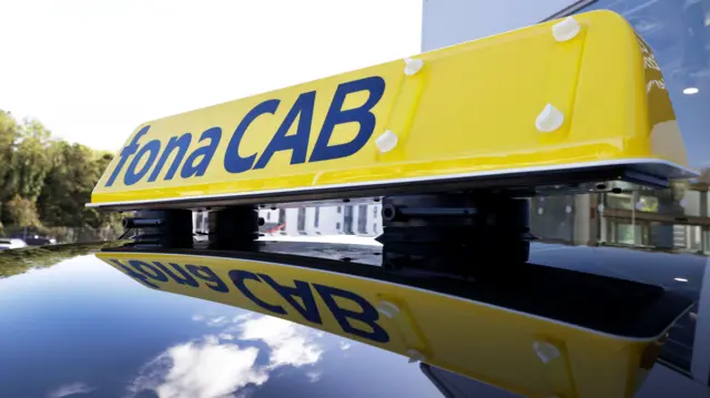 Close-up of a yellow sign that says 'fona CAB'