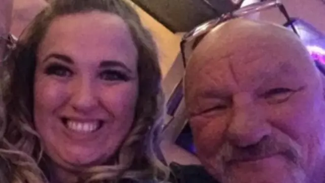 A woman smiling beside a man