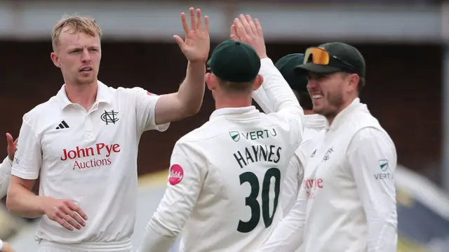 Lyndon James of Nottinghamshire celebrates with his team mates after taking the wicket of Robin Das