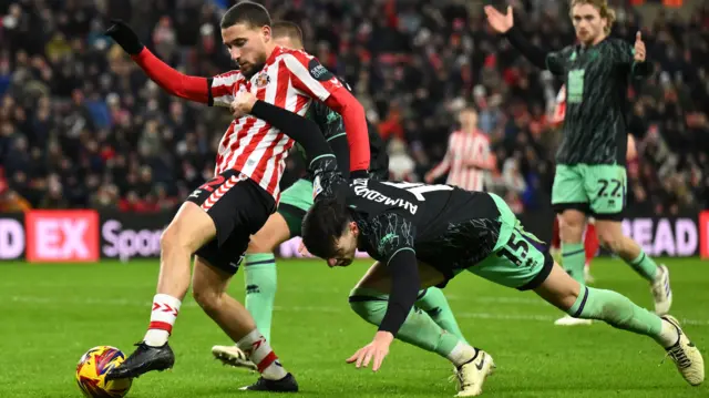 Anel Ahmedhodzic of Sheffield United challenges Adil Aouchiche of Sunderland