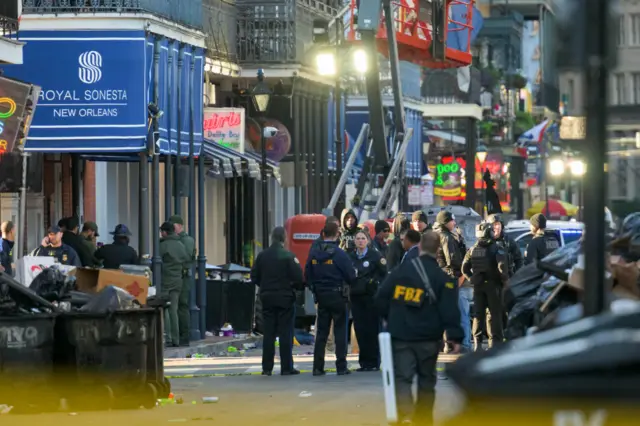 Dozens of FBI and police gather on a street in New Orleans