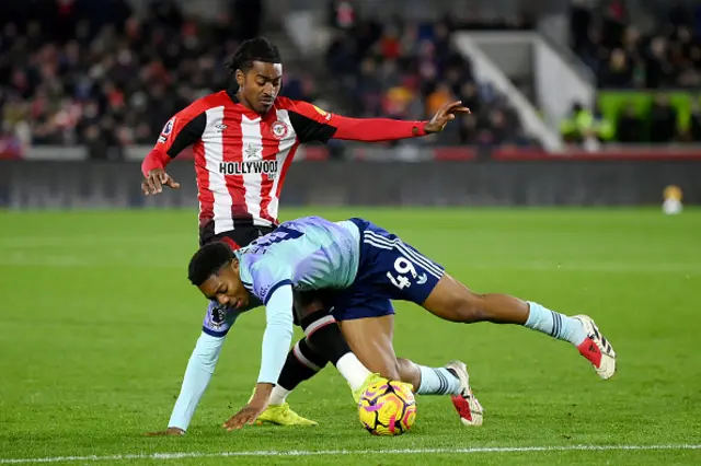 Myles Lewis-Skelly of Arsenal is challenged by Paris Maghoma