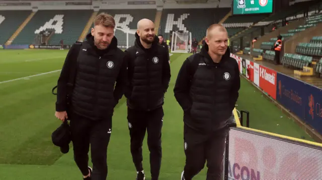 Bristol City head coach Liam Manning (right) with assistants Chris Hogg and James Krause arrives at Home Park