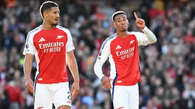 William Saliba and Gabriel of Arsenal react