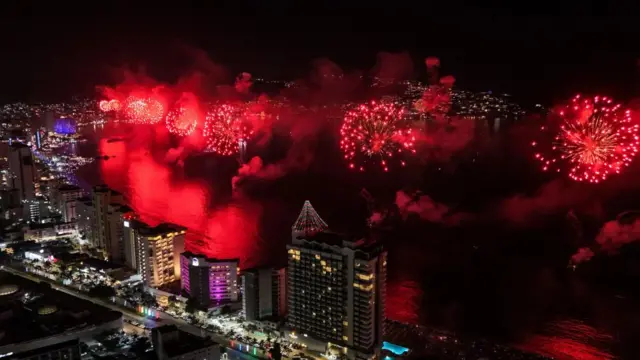 An image taken by a drone shows fireworks lighting up the evening sky as part of the New Year's celebrations in Acapulco, Mexico