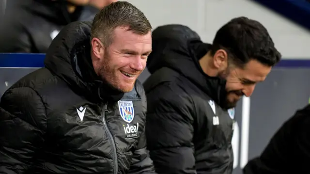 West Brom interim head coach Chris Brunt smiles during their win over Preston