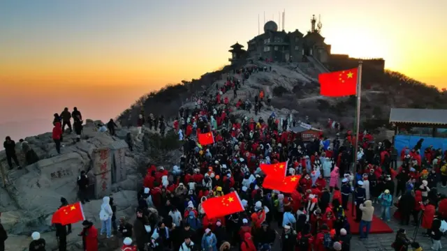 Climbers watch the sunrise on New Year's Day on Mount Tai on January 1, 2025 in Taian, Shandong Province of China
