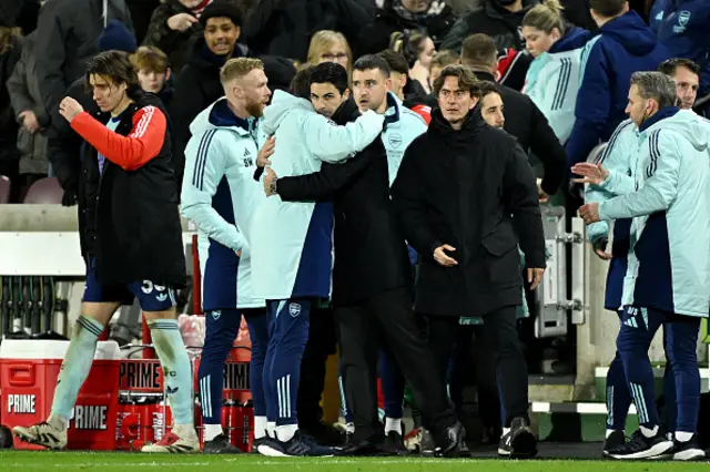 Mikel Arteta, Manager of Arsenal, celebrates victory as Thomas Frank looks on