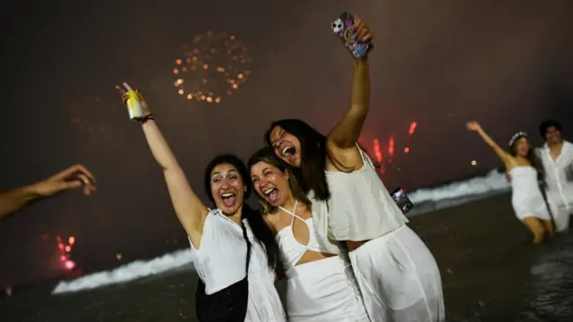 People gather at Copacabana beach to celebrate the New Year, in Rio de Janeiro, Brazil