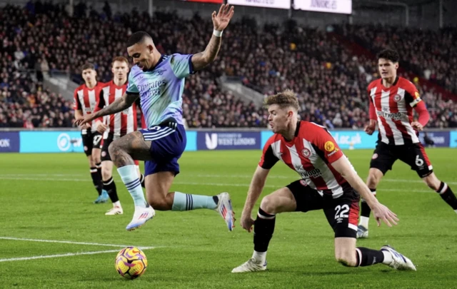 Arsenal's Gabriel Jesus (left) gets past Brentford's Nathan Collins