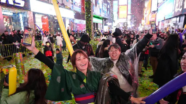 People react after the ball drop at Times Square during New Year's celebrations in New York City, U.S