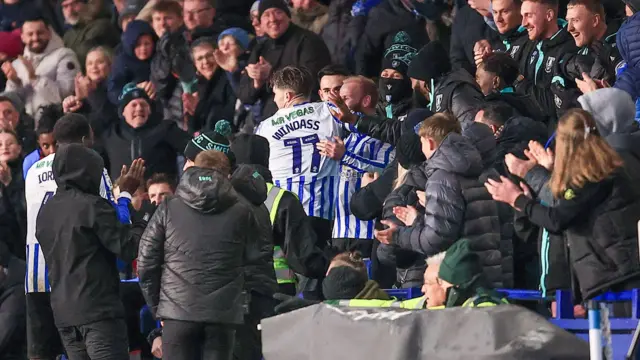 Josh Windass ends up in the crowd after scoring from inside his own half against Derby