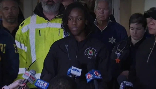 Headshot of Althea Duncan with multiple microphones being held in front of her