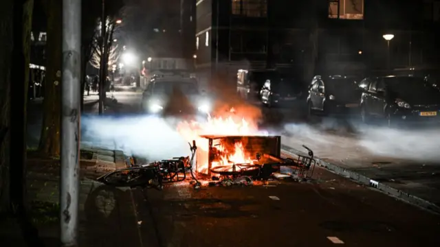 A bin and multiple bicycles are on fire after fireworks were set off in Amsterdam on new year's eve.