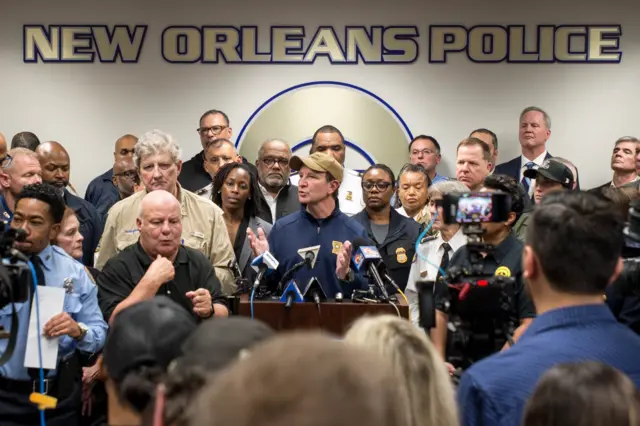 Louisiana Governor Jeff Landry speaking to the media in front of a background saying 'New Orleans Police'