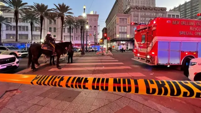 A police site is taped off and officers are seen on horses