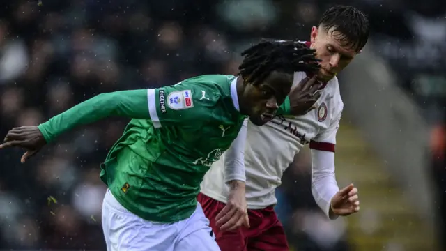 Darko Gyabi of Plymouth Argyle battles for the ball with Bristol City midfielderMax Bird