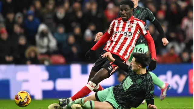 Anel Ahmedhodzic of Sheffield United slides in with a challenge on Eliezer Mayenda of Sunderland