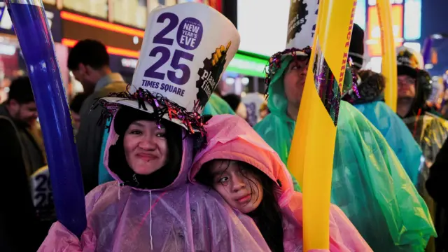 People react at Times Square during New Year's Eve celebrations in New York City, U.S