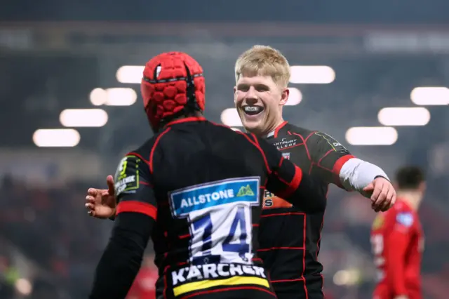 Christian Wade of Gloucester celebrates with team-mate George Barton after scoring a try