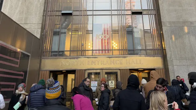 People waiting outside a building