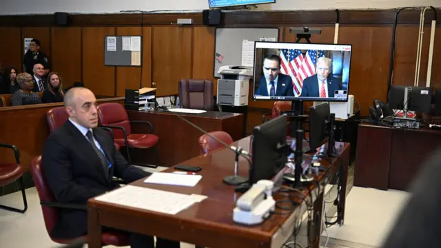 Todd Blanche, attorney for former US President Donald Trump, and US President-elect Donald Trump are seen on the screen at Manhattan criminal court in New York, US, on Friday, Jan. 10, 2025.