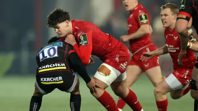 Eddie James of Scarlets is tackled by Santi Carreras of Gloucester