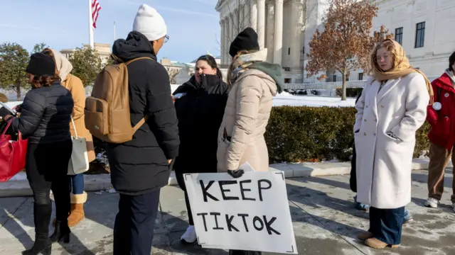 A woman with a sign outside the Supreme Court that reads 'Keep TikTok'