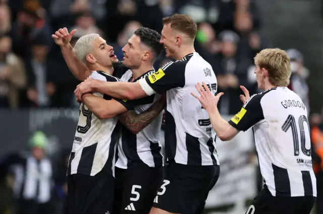 Bruno Guimaraes and Fabian Schar celebrate with Newcastle team-mates