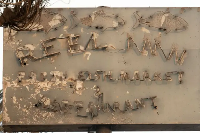 The burned sign of The Reel Inn restaurant in Malibu