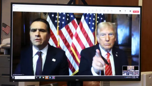 Todd Blanche and Donald Trump on a computer monitor