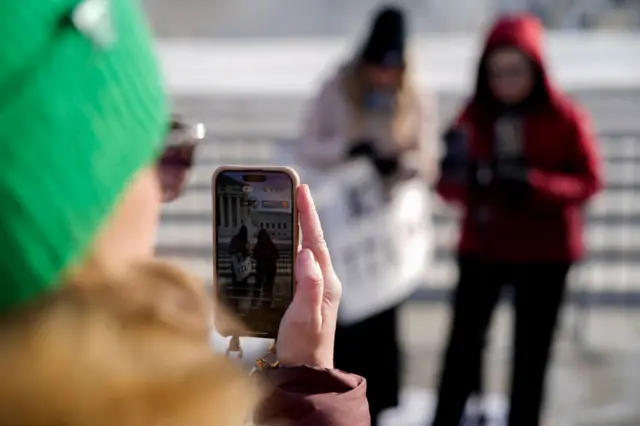 A woman films two others on TikTok