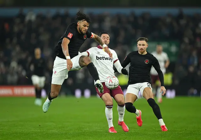 Tyrone Mings of Aston Villa looks to control the ball