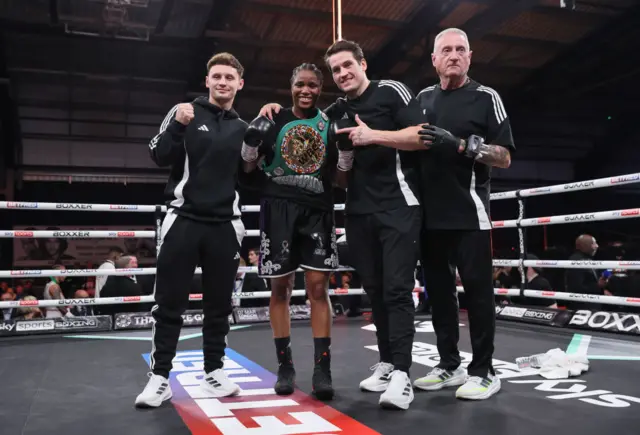 Caroline Dubois poses with her team including trainer Shane McGuigan in the ring after a fight