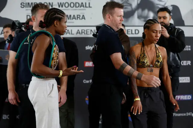 Caroline Dubois gestures to Jessica Camara as she is ushered off stage at a weigh-in