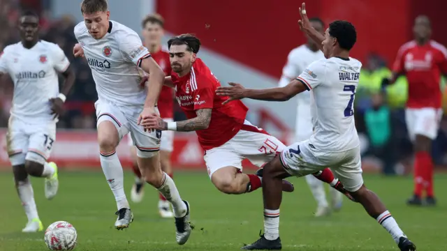 Nottingham Forest's Jota Silva in action with Luton Town's Mark McGuinness and Reuell Walters