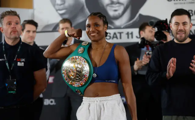 Caroline Dubois holds the WBC lightweight title over her shoulder