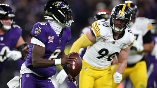 Ravens quarterback Lamar Jackson is chased by TJ Watt