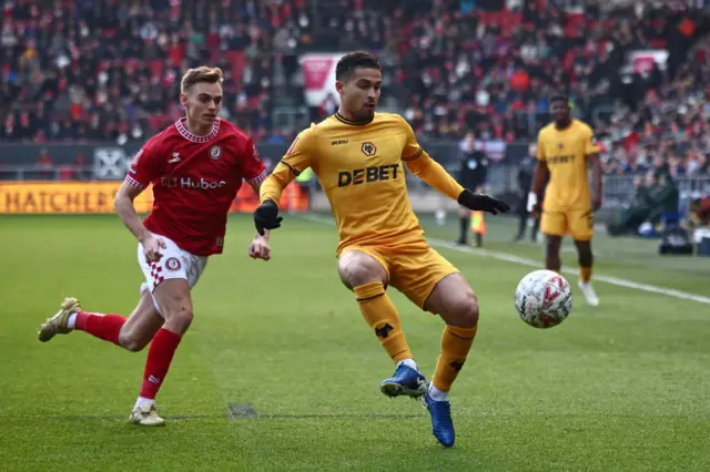 Joao Gomes battles for the ball