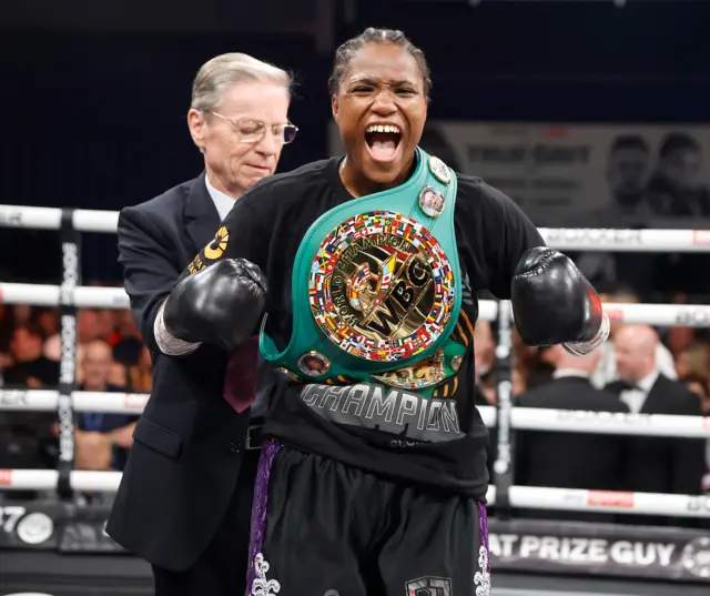 Caroline Dubois celebrates with the WBC world title around her shoulder