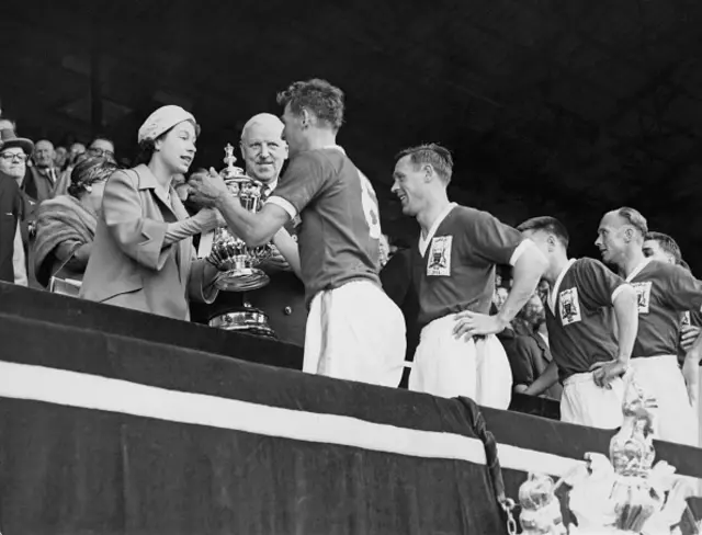 HRH Queen Elizabeth II presents the Football Association trophy to Nottingham Forest Football Club team captain Jack Burkitt