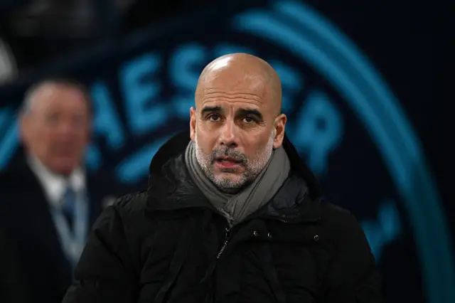 Pep Guardiola, Manager of Manchester City, looks on