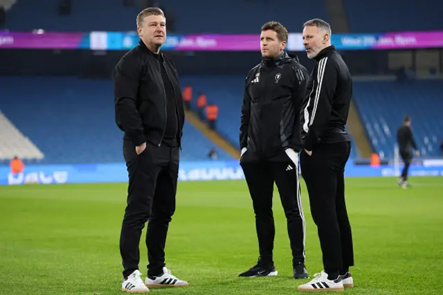 Karl Robinson, Manager Salford City is pictured talking to Ryan Giggs and Alex Bruce