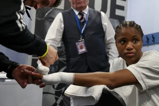 Caroline Dubois gets her hands wrapped backstage