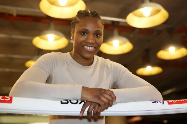 Caroline Dubois leans on the top rope of a boxing ring